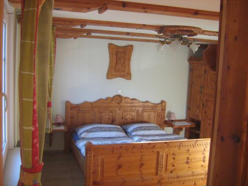 a bedroom with a wooden bed in a room at Das Haus am See in Grundlsee
