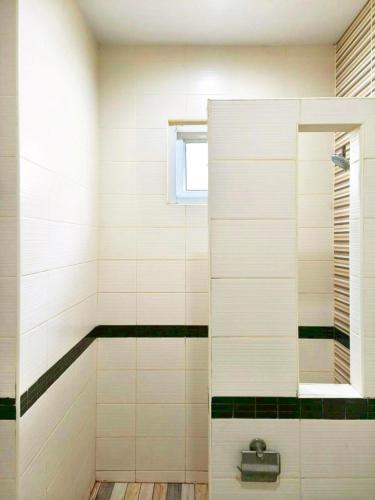 a bathroom with a shower with black and white tiles at Phala Beach Rayong Palm Villa 2BR2BA in Ban Phala