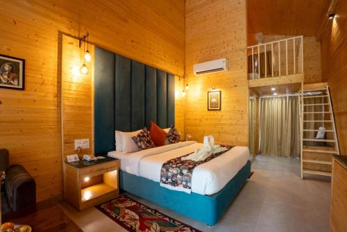 a bedroom with a bed in a room with wooden walls at Bamboo Saa Mulberry Resort Pushkar in Pushkar