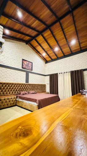 a large room with a bed and a wooden table at Airport Hotel Transit 98 in Katunayaka