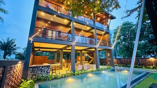 a house with a swimming pool in front of it at Airport Hotel Transit 98 in Katunayaka