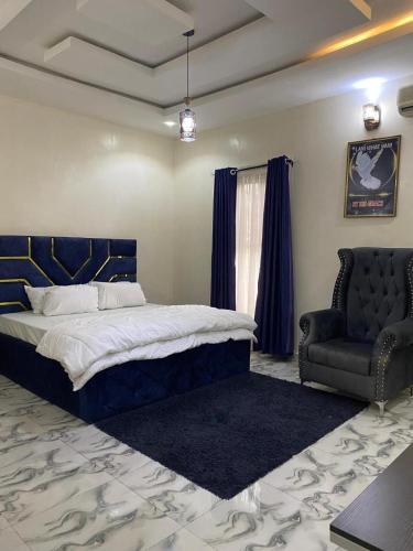 a bedroom with a bed and a couch and a chair at Starlight Homes in Asaba
