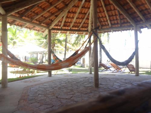 a hammock in a gazebo at Pousada Terceiro Espaço in Guaibim