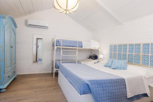 a bedroom with two bunk beds and a chandelier at Camping Car Palmasera in Cala Gonone