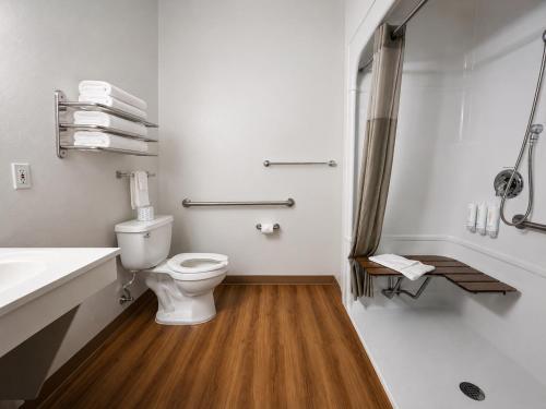 a white bathroom with a toilet and a sink at Econo Lodge Menomonie in Menomonie