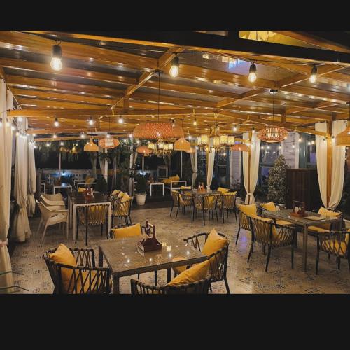 a dining room with tables and chairs and lights at Hotel Parth Inn in Haldwāni