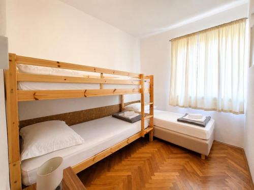 a bedroom with two bunk beds and a window at Garden House Tučepi in Tučepi