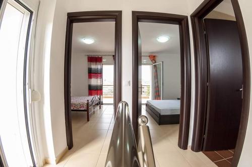 a room with a mirror and a bedroom with a bed at Paliouri Villas in Paliouri