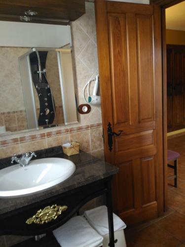a bathroom with a sink and a mirror at Posada Carpe Diem in Liérganes