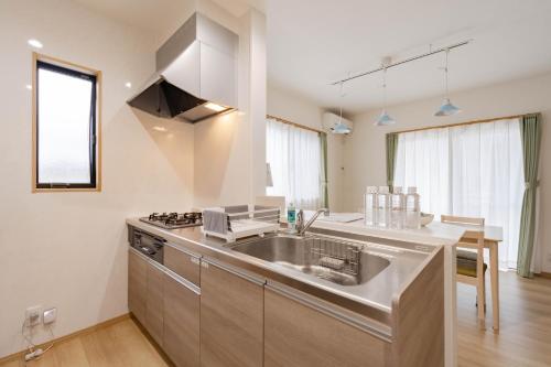 a kitchen with a sink and a stove at Fujiyama Stay101 in Fujinomiya