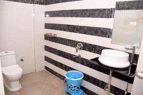 a bathroom with a black and white striped wall at Hotel J P Residency in Datia
