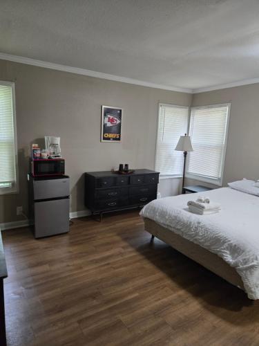 a bedroom with a bed and a dresser and two windows at Tranquil Retreat-Off the Beaten Path in Independence