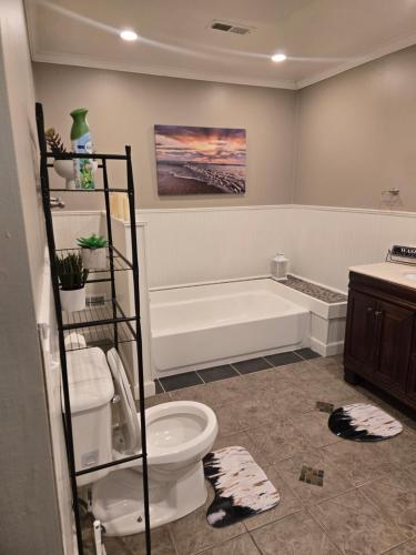 a bathroom with a toilet and a bath tub at Tranquil Retreat-Off the Beaten Path in Independence