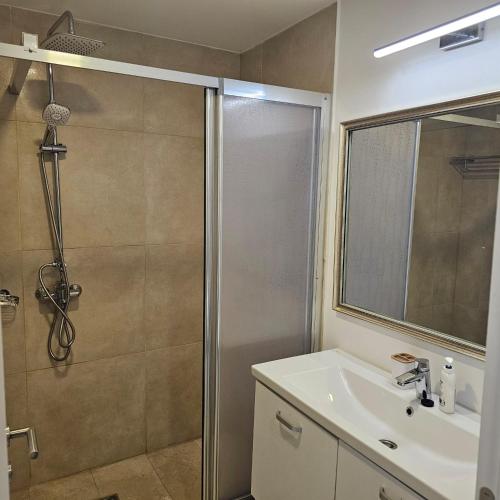 a bathroom with a shower and a sink at CHARLOTTE STUDIOS BY BLAXY RESORT Olimp in Olimp