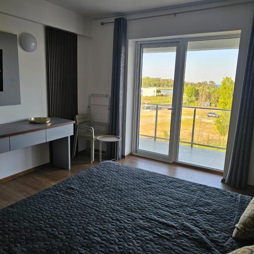 a bedroom with a bed and a window with a view at CHARLOTTE STUDIOS BY BLAXY RESORT Olimp in Olimp