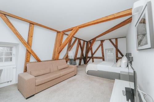 a living room with a couch and a bed at Hotel Château Gbeľany in Žilina
