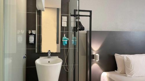 a bathroom with a shower with a toilet in it at The Leverage Business Hotel - Rawang in Rawang