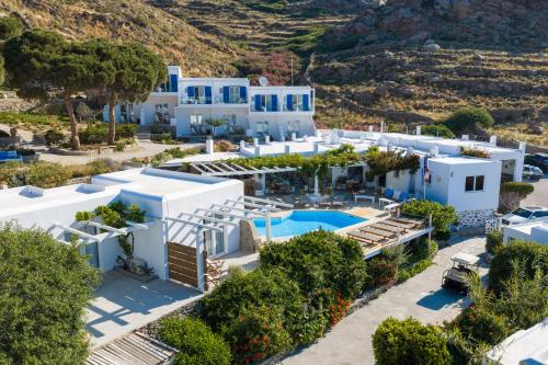 an aerial view of a white villa with a swimming pool at Rhenia Mykonos Hotel & Bungalows in Tourlos