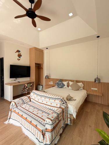 a bedroom with a bed with a ceiling fan at Aonang nine poolvilla resort in Ao Nang 