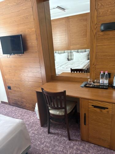 a bedroom with a desk with a mirror and a bed at Prince Cyril Hotel in Nesebar