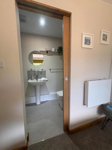 a bathroom with a sink and a toilet at Gatwick 'Bit on the Side' in Copthorne