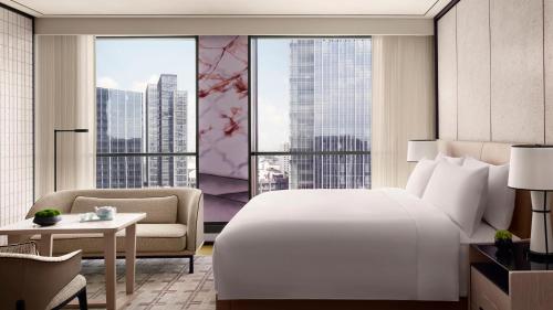 a bedroom with a white bed and a large window at The Ritz-Carlton, Suzhou in Suzhou