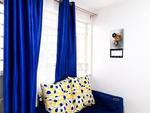 a blue curtain in a room with a window at Annie's studio near Westside mall in Nakuru