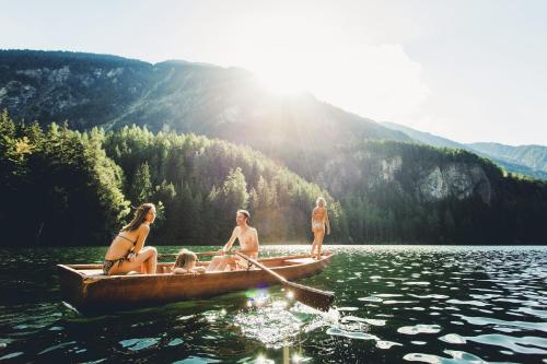 three women are sitting on a boat in the water at Gasthof Ambachhof in Oetz
