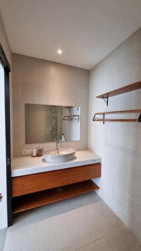 a bathroom with a sink and a mirror at Sari Hills Bali in Nusa Dua