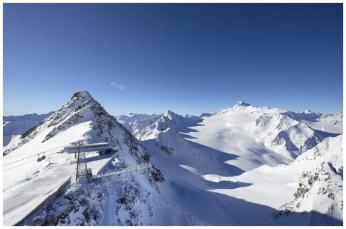 a ski lift on top of a snowy mountain at Gasthof Ambachhof in Oetz