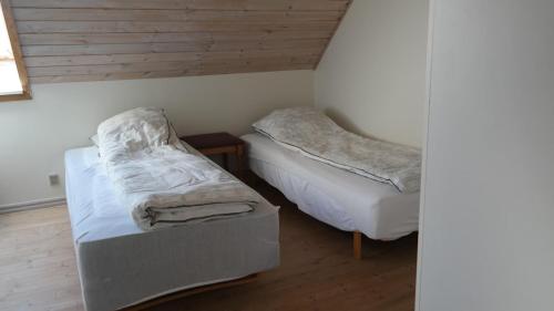 a room with two beds and a ottoman in it at Central located Large apartment on the 1st floor tv in Hjørring