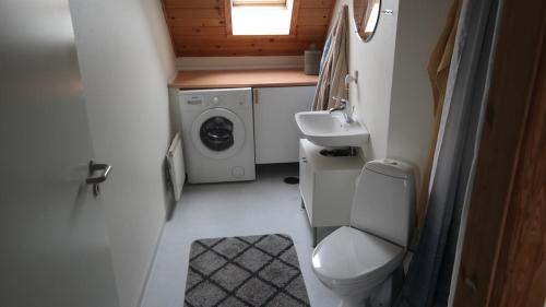 a small bathroom with a toilet and a sink at Central located Large apartment on the 1st floor tv in Hjørring