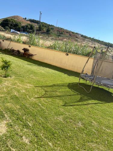 a chair sitting on the grass in a yard at Ale Mac in Carrao
