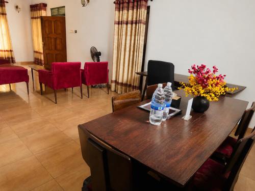 a dining room with a table with water bottles on it at Sattvic Ceylon- Wellness Homestay in Colombo