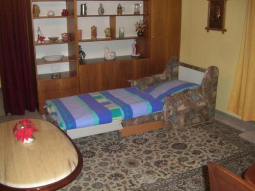 a small bedroom with a bed and a table at Ferien Penthouse Panoramablick oder Studio Panoramablick in Bad Grund