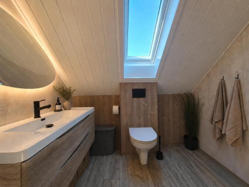 a bathroom with a sink and a toilet and a window at Stunning 3-Bedroom Apartment at Feda Waterfront in Feda