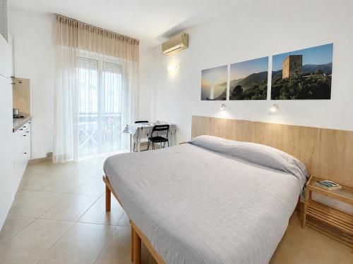 a bedroom with a bed and a table in it at Residence Glicini in Finale Ligure
