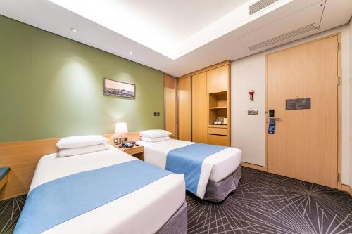 a hotel room with two beds in it at Days Hotel by Wyndham Seoul Myeongdong in Seoul