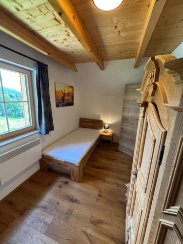 a small room with a bed and a window at Alpenchalet Sonnberg in Kalwang