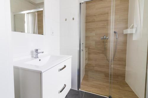 a bathroom with a sink and a shower at BLOMMA Niechorze in Niechorze