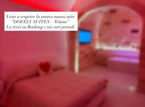 a red bedroom with a bed and a sign that reads want a surprise in master at Dofely Suites - Gelso in Polignano a Mare