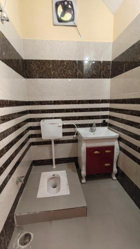 a bathroom with a toilet and a sink at The Stay Spot in Kharar