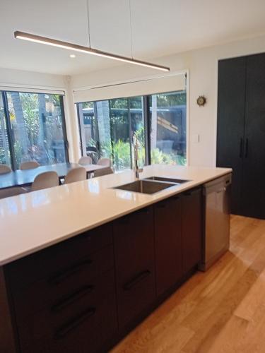 a kitchen with a sink and a counter at Mangawhai Palms in Mangawhai
