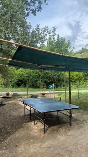 a ping pong table with a canopy over it at Altaluna tiny house sotto le stelle in Trebbiantico