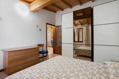 a bedroom with a bed and a desk in a room at I Bibi Vacation Home in Viareggio