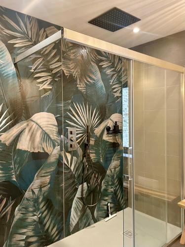 a shower stall with a mural of plants at Big Jungle in Grane