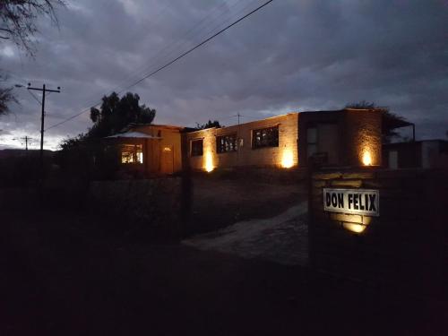 a house with its lights on in the dark at Lodge Don Felix in San Pedro de Atacama