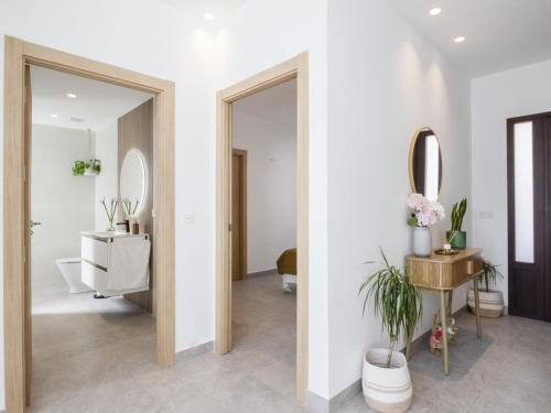 a bathroom with a toilet and a sink and a mirror at Casa Regalo in Dúrcal