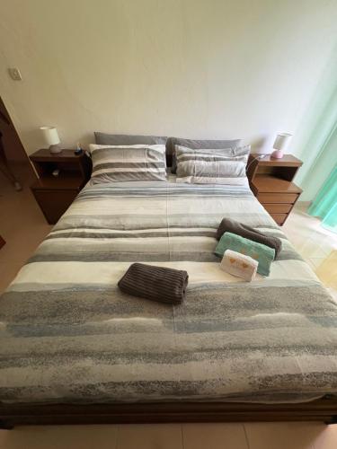 a large bed with two pillows on top of it at La casa di nonna Gianna in Gonnesa
