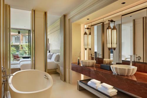 a bathroom with two sinks and a large mirror at THE BARAI HUA HIN - The Unbound Collection by Hyatt in Hua Hin